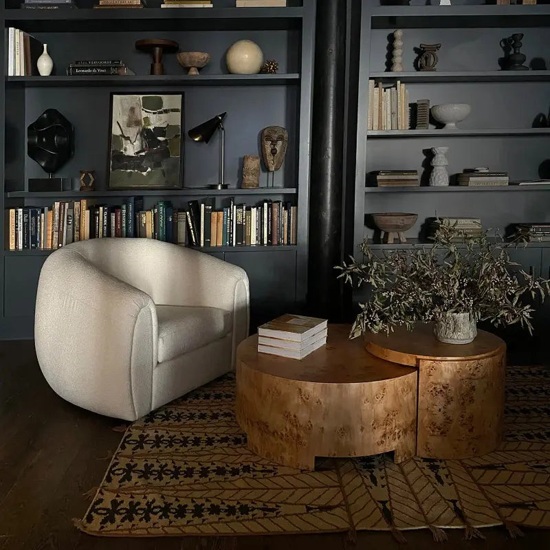 Round bunching coffee tables with white chair and bookcases in behind